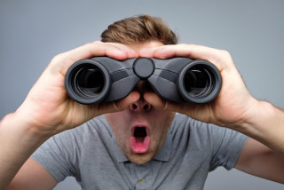 man-looking-through-binoculars-with-rprise-studio-shoot_262388-5398